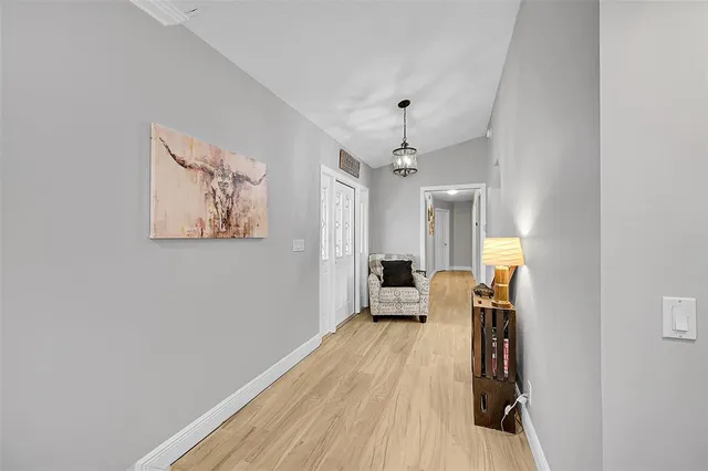 a bedroom with a bed and a flat tv screen on dresser