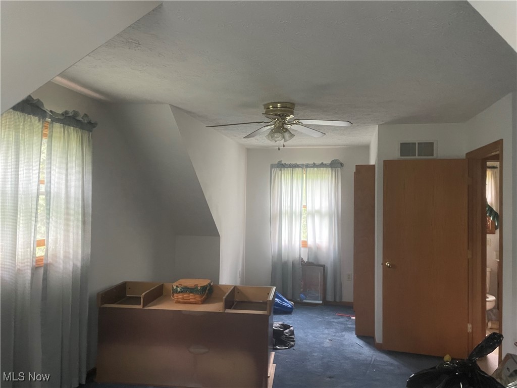Bedroom featuring a textured ceiling and ceiling fan