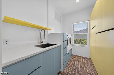 a kitchen with a sink and wooden floor