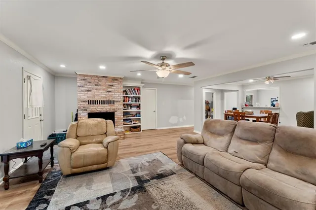 a living room with furniture and a ceiling fan
