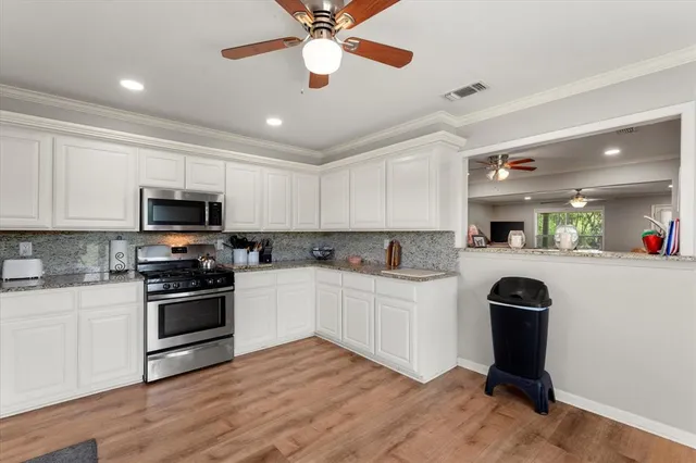 a kitchen with a sink a stove and microwave
