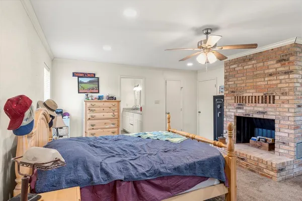 a bedroom with a bed and a fireplace