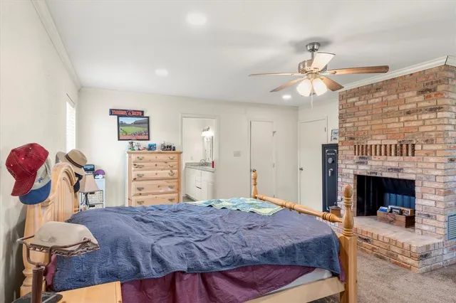 a bedroom with a bed and a fireplace