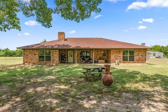 a front view of a house with yard porch and furniture