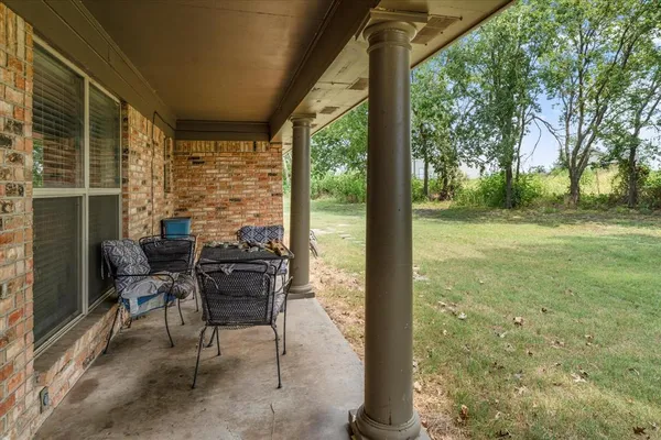 a view of a chairs in backyard of house
