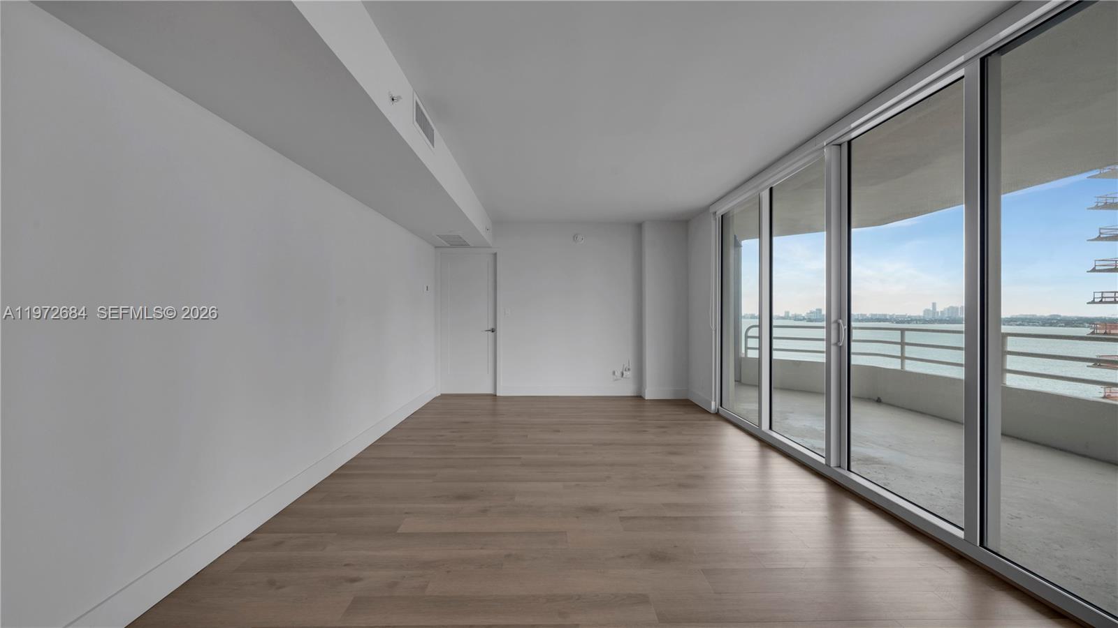 555 Northeast 34th Street, Unit 2607 Miami, FL 33137 - Photo 12 of 35 a view of an empty room and glass door