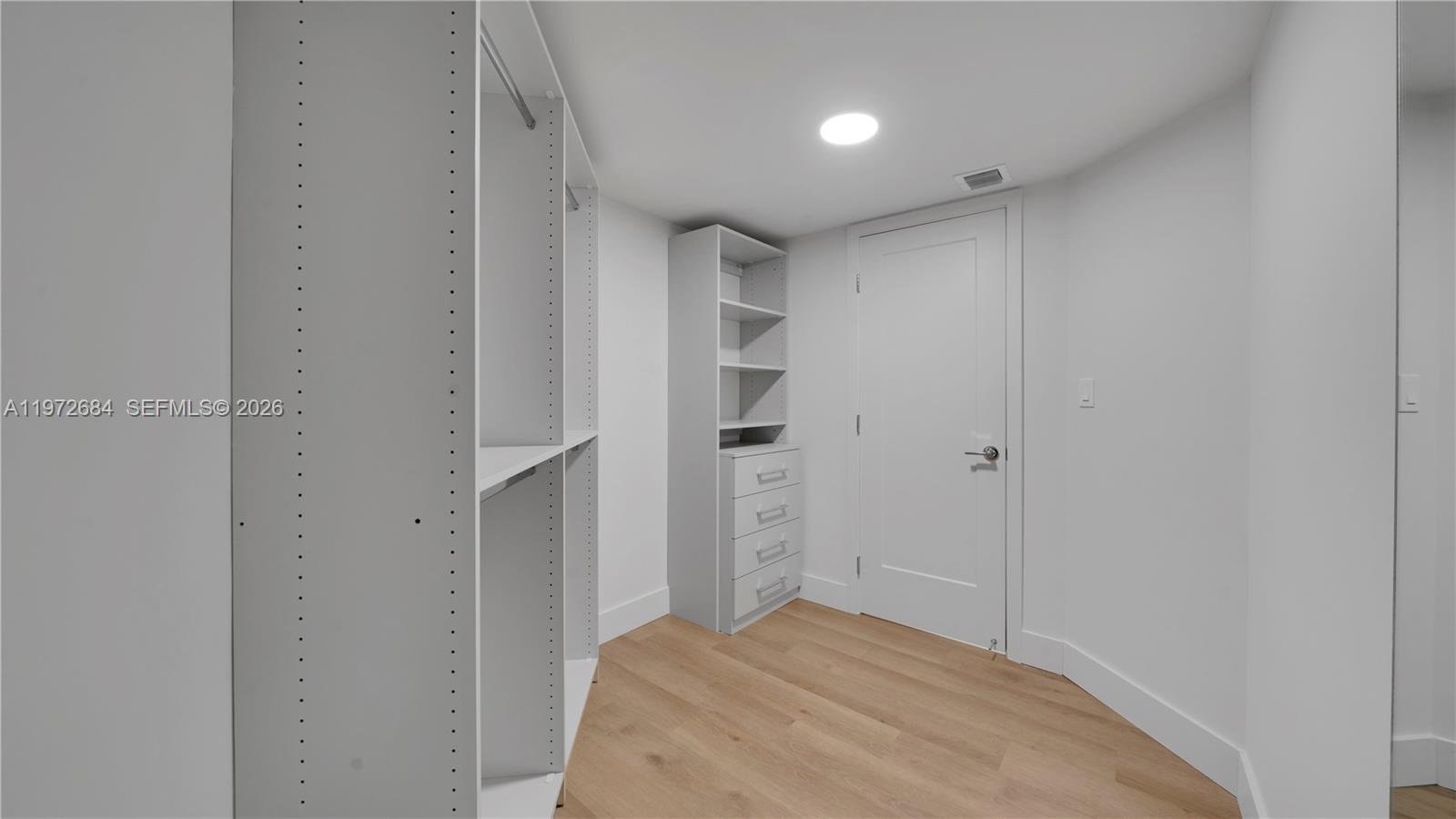 555 Northeast 34th Street, Unit 2607 Miami, FL 33137 - Photo 24 of 35 a bedroom with a bed and cabinets