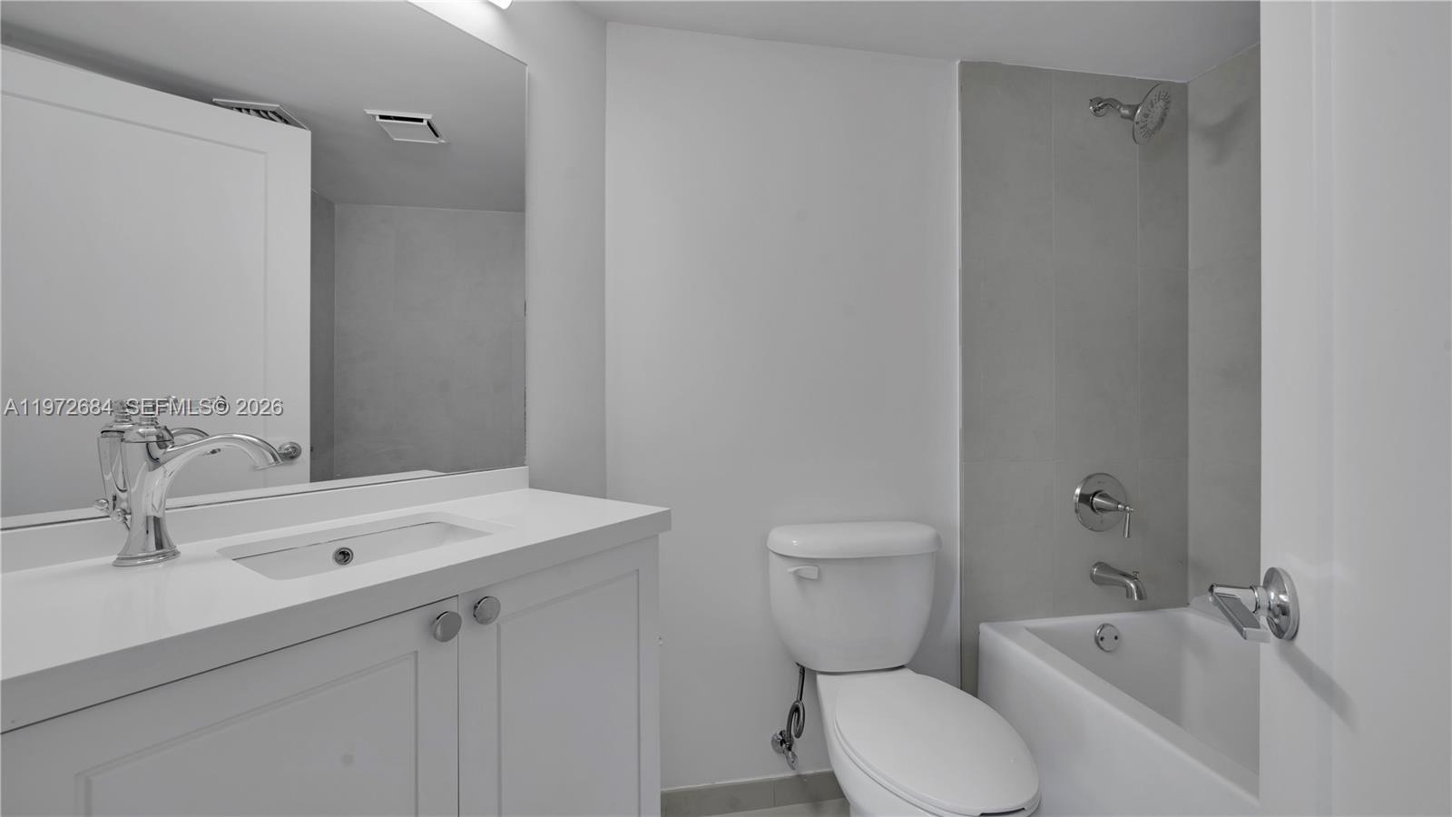555 Northeast 34th Street, Unit 2607 Miami, FL 33137 - Photo 32 of 35 a bathroom with a sink toilet and shower