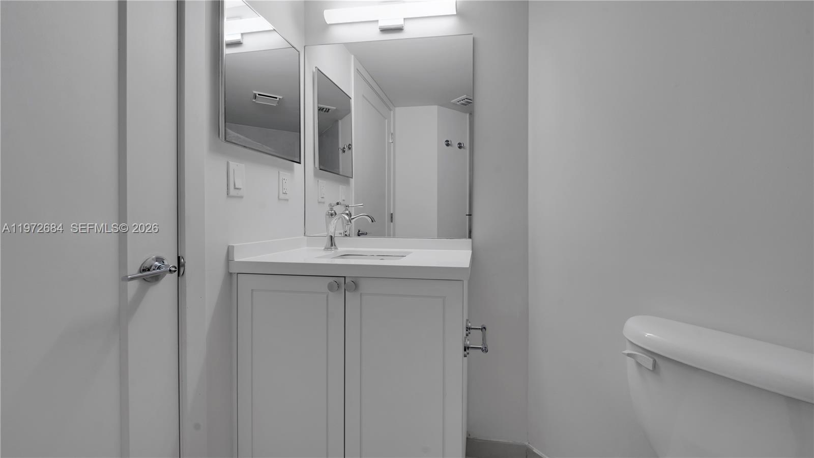 555 Northeast 34th Street, Unit 2607 Miami, FL 33137 - Photo 35 of 35 a bathroom with a sink and mirror