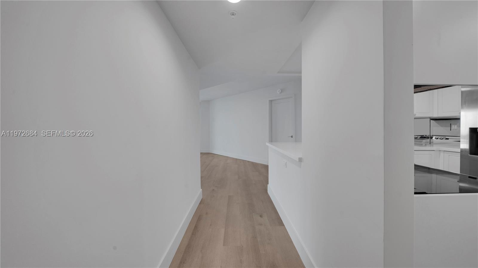 555 Northeast 34th Street, Unit 2607 Miami, FL 33137 - Photo 7 of 35 a view of a hallway with wooden floor and entryway