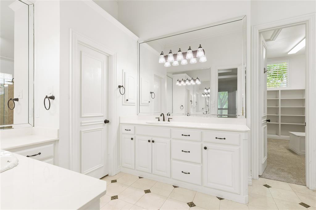 967 East Bethel School Road Coppell, TX 75019 - Photo 26 of 39 Bathroom featuring dual vanities with white cabinetry, white countertops, and black fixtures