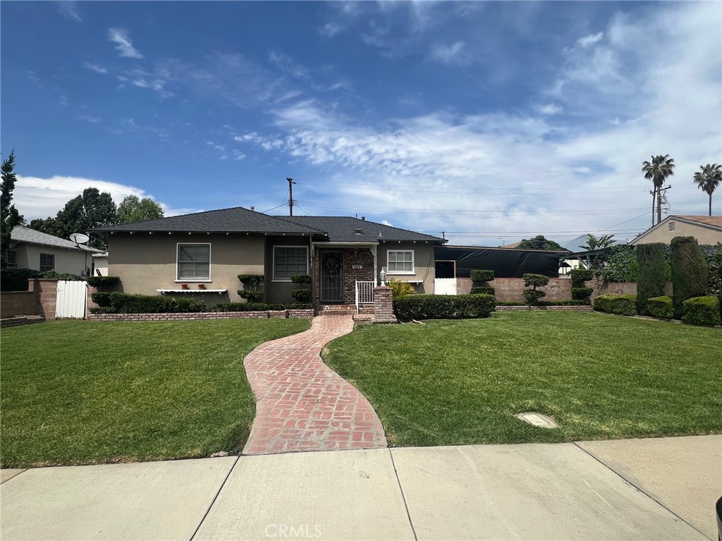 223 Albert Avenue Pomona, CA 91767 - Photo 1 of 18 a front view of a house with a garden