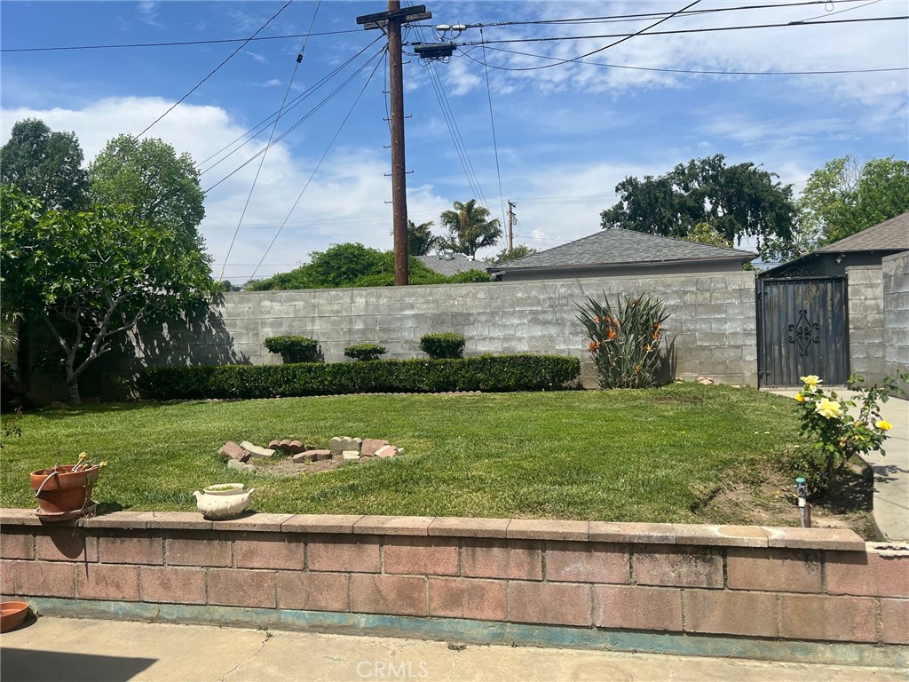 223 Albert Avenue Pomona, CA 91767 - Photo 14 of 18 a view of a garden with a bench in the background