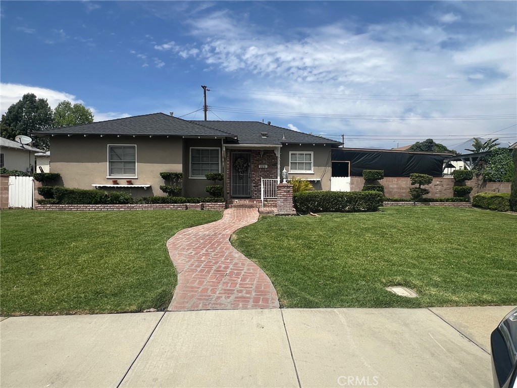 223 Albert Avenue Pomona, CA 91767 - Photo 2 of 18 a front view of a house with a yard