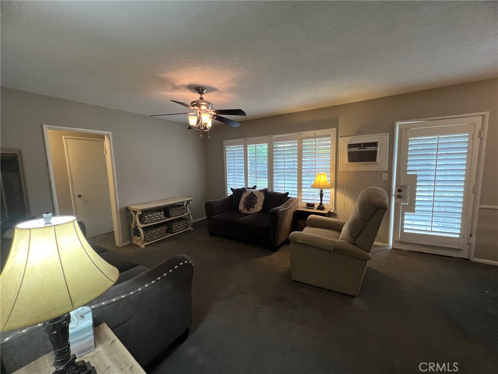 223 Albert Avenue Pomona, CA 91767 - Photo 8 of 18 a living room with furniture and a lamp