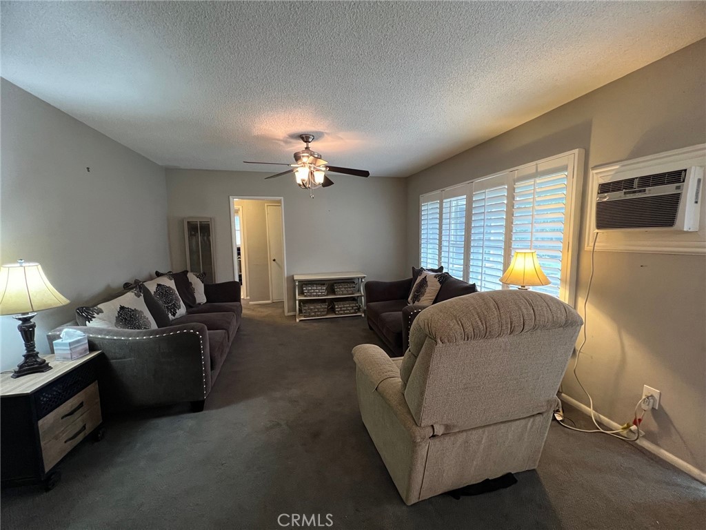 223 Albert Avenue Pomona, CA 91767 - Photo 9 of 18 a living room with furniture and a chandelier
