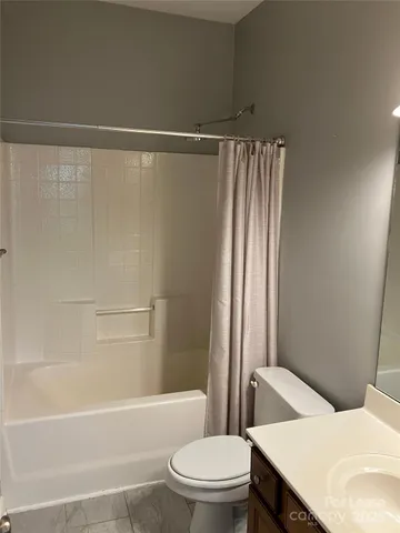 a bathroom with a sink a toilet a bathtub and shower