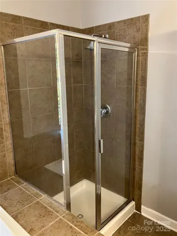 a bathroom with a shower and toilet
