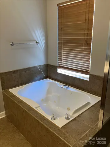 a bath tub sitting next to a window