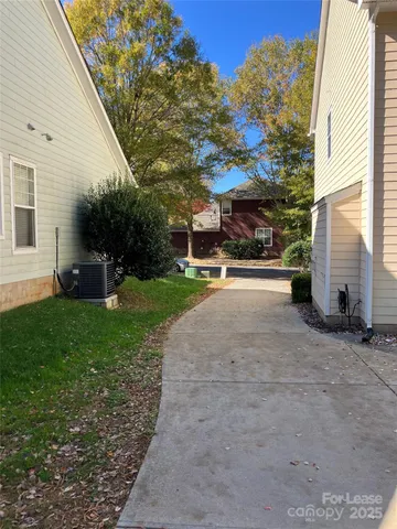 a view of a house with backyard and a tree