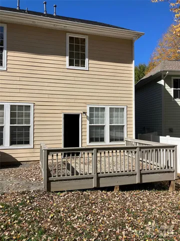 a view of a house with wooden fence
