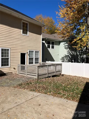 a view of a house with wooden fence