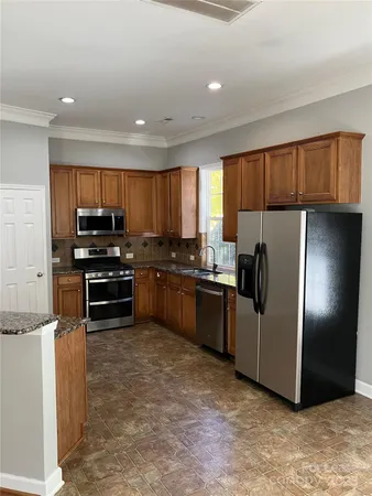 a kitchen with granite countertop stainless steel appliances and cabinets