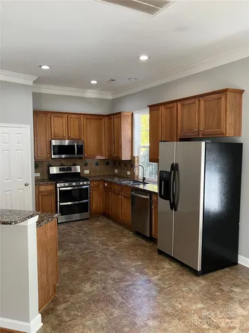 a kitchen with granite countertop stainless steel appliances and cabinets