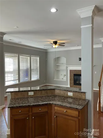 a bathroom with a granite countertop sink and a large mirror
