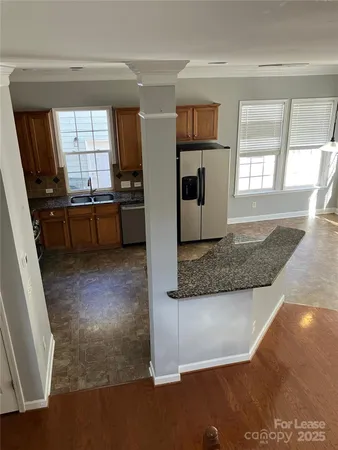 a view of a kitchen with a sink hardwood floor and a window