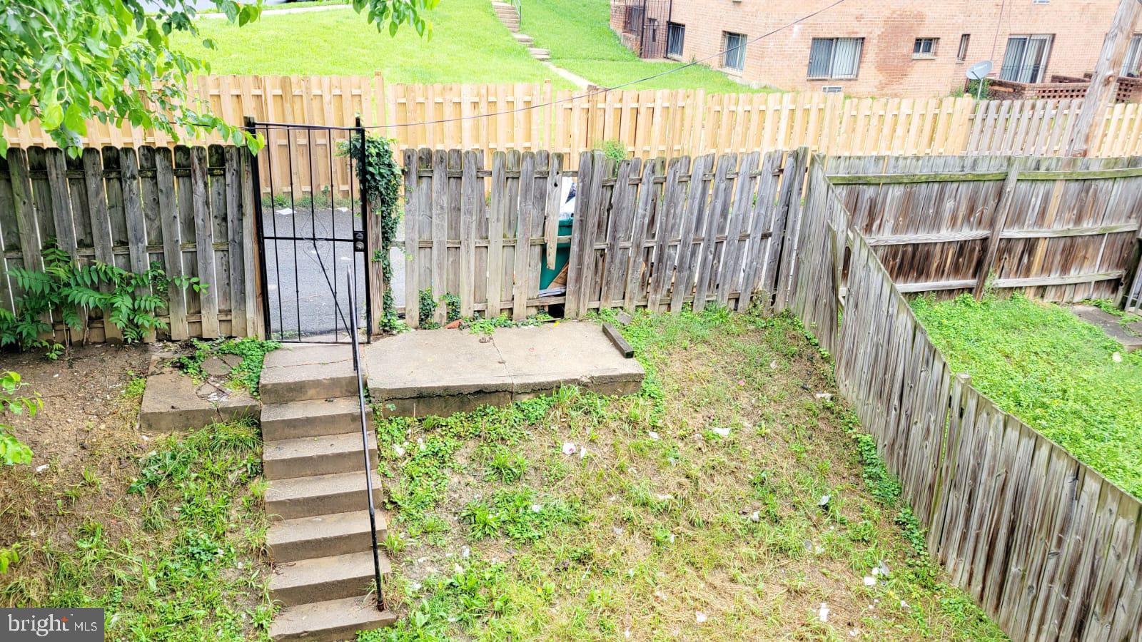 1712 Capitol Avenue Northeast Washington, DC 20002 - Photo 4 of 15 a backyard of a house with a garden and plants