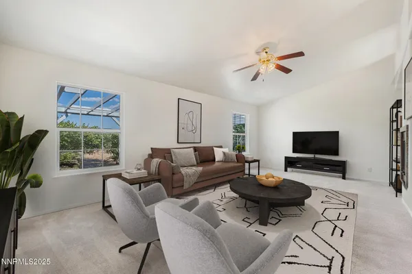 a living room with furniture a rug and a window