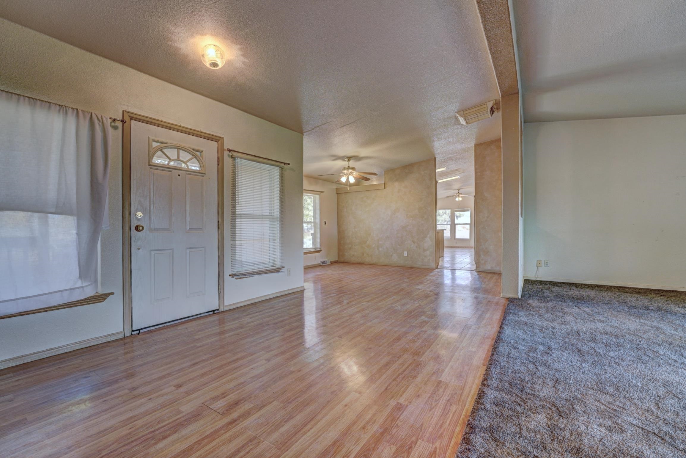 694-29 29 1/2 Road Grand Junction, CO 81504 - Photo 4 of 27 a view of a hallway with wooden floor