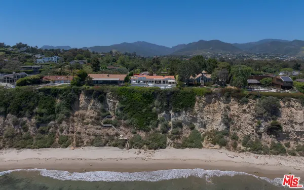 an aerial view of a house with swimming pool outdoor seating and yard