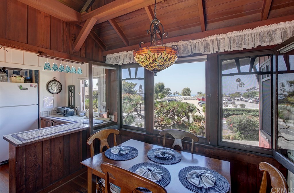 310 Hawthorne Road Laguna Beach, CA 92651 - Photo 12 of 25 a view of a dining room with furniture a chandelier and wooden floor