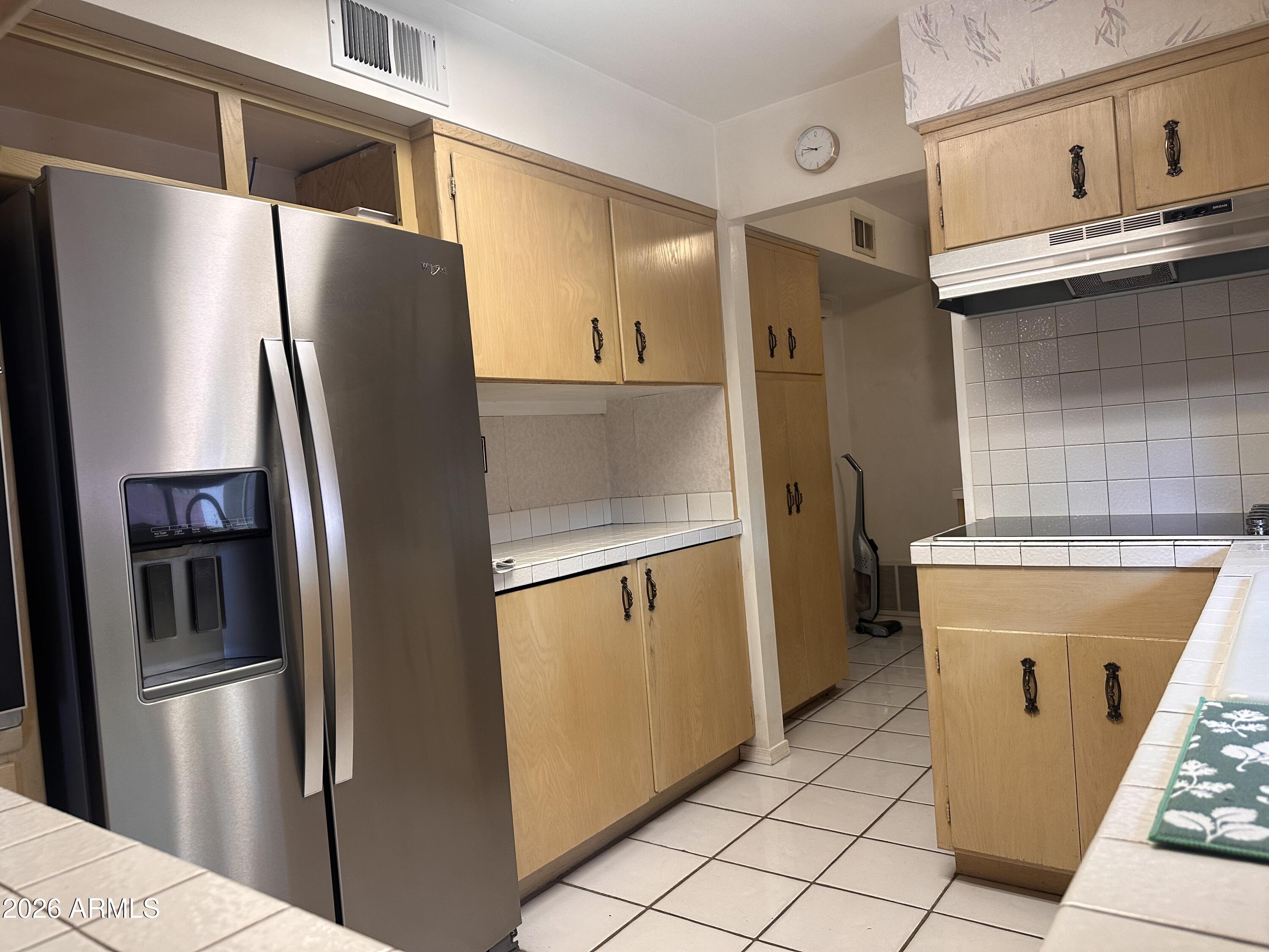 2821 West Elliot Road Laveen, AZ 85339 - Photo 15 of 92 a metallic refrigerator freezer sitting inside of a kitchen