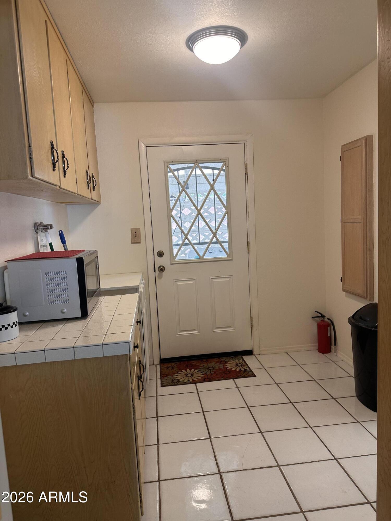 2821 West Elliot Road Laveen, AZ 85339 - Photo 21 of 92 a kitchen with a sink a stove top oven and cabinets