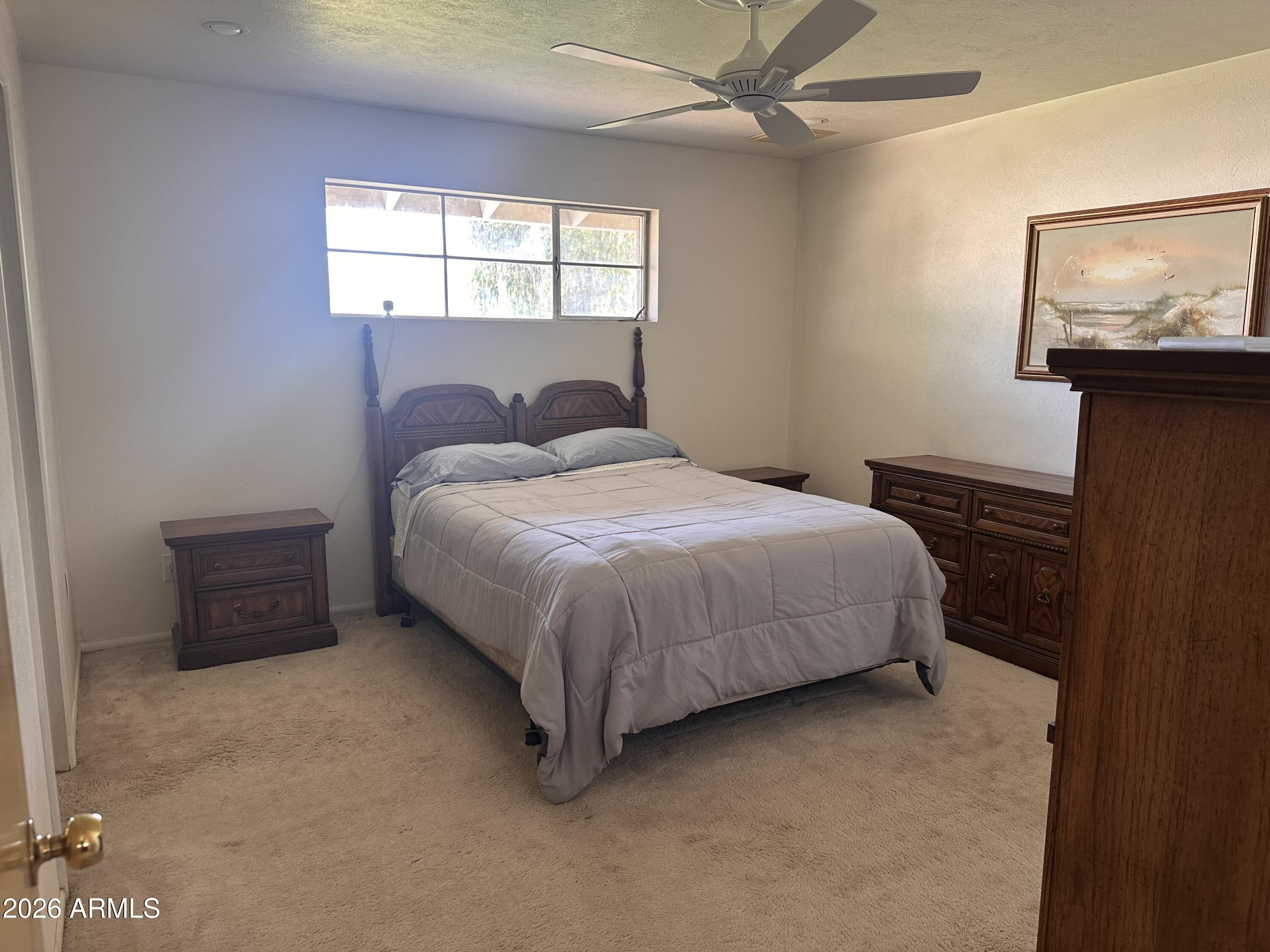 2821 West Elliot Road Laveen, AZ 85339 - Photo 33 of 92 a large bed sitting in a bedroom next to a window