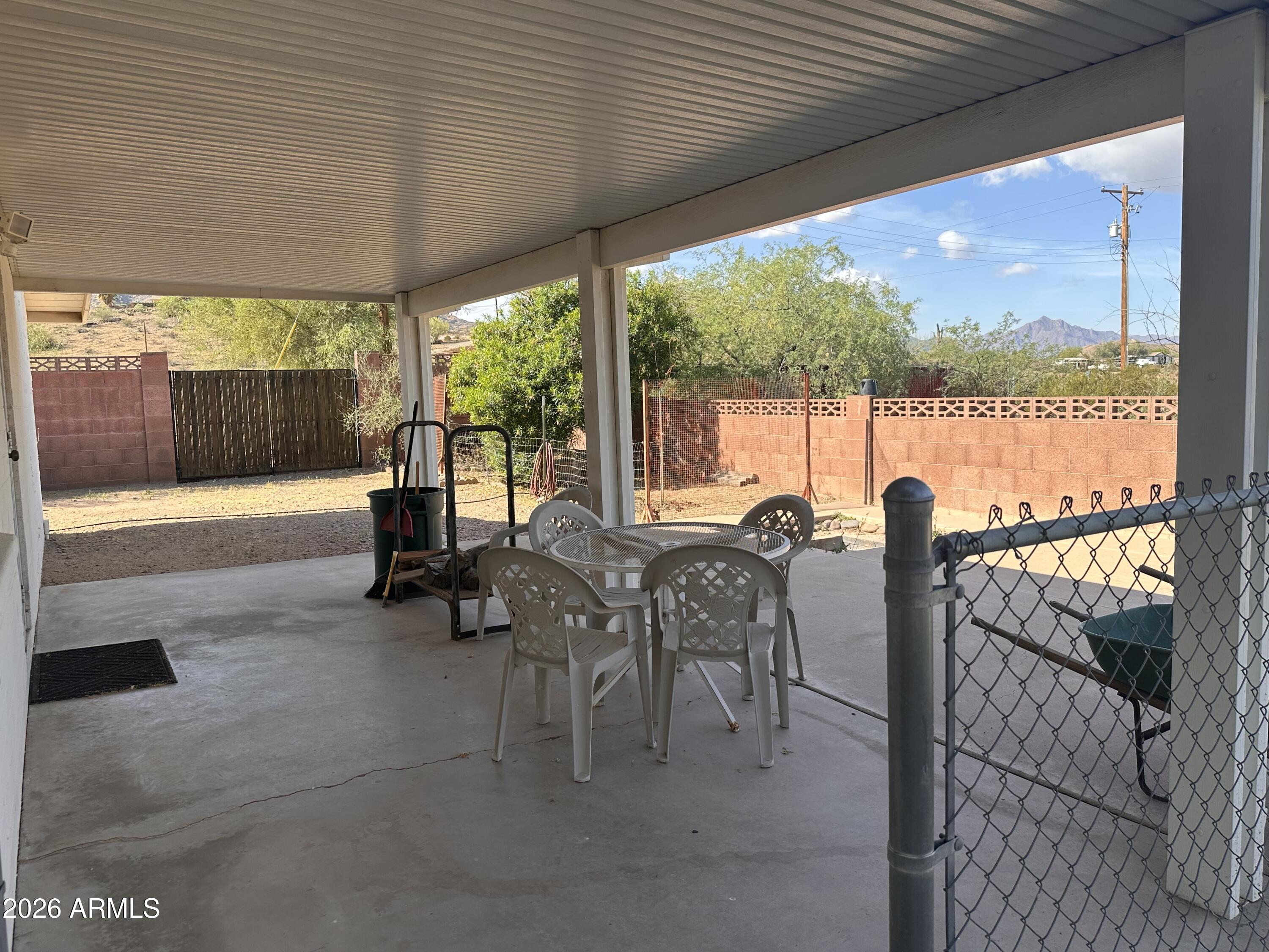2821 West Elliot Road Laveen, AZ 85339 - Photo 44 of 92 a view of a patio with a table chairs and backyard