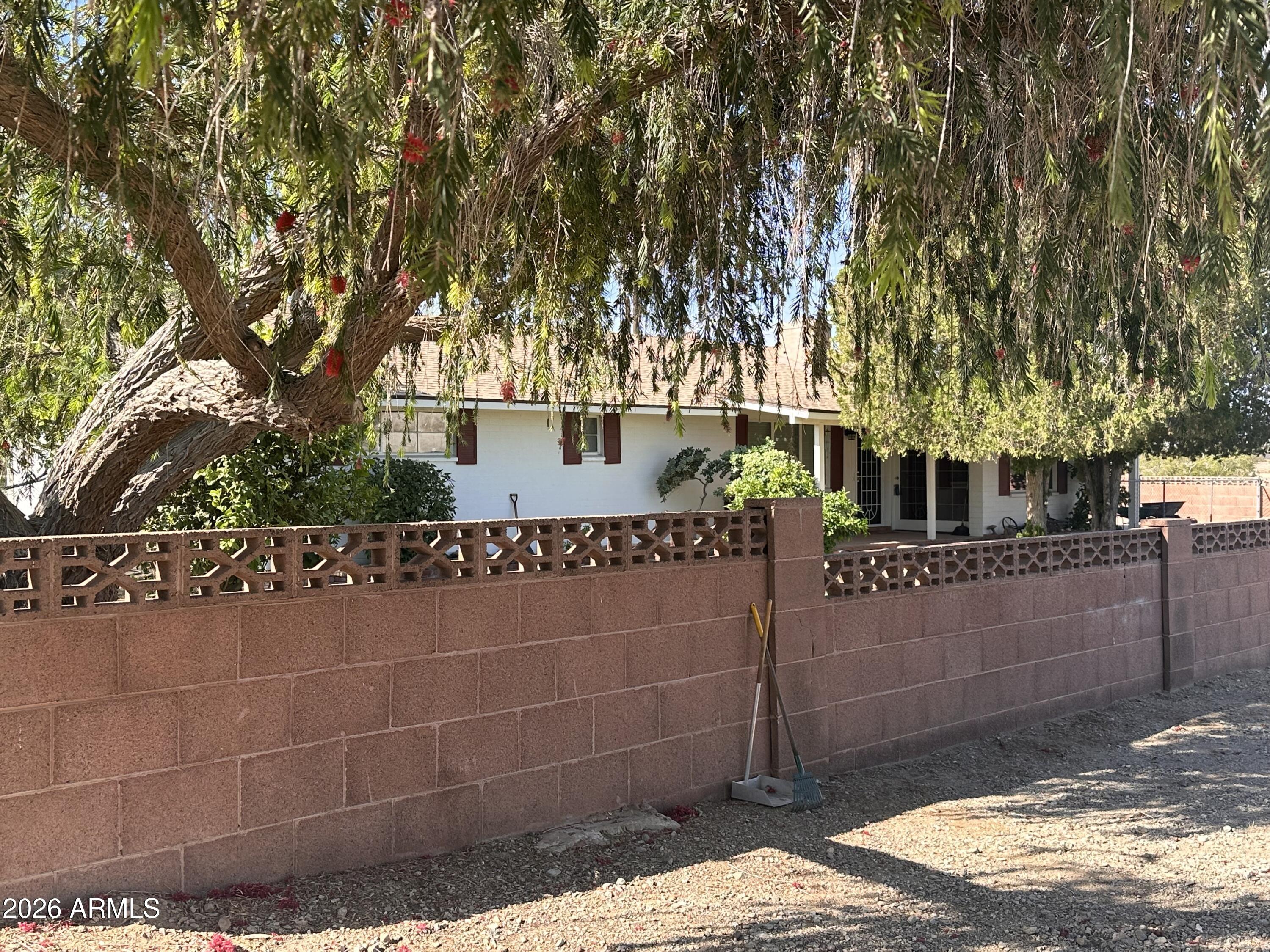 2821 West Elliot Road Laveen, AZ 85339 - Photo 5 of 92 a front view of a house with a tree
