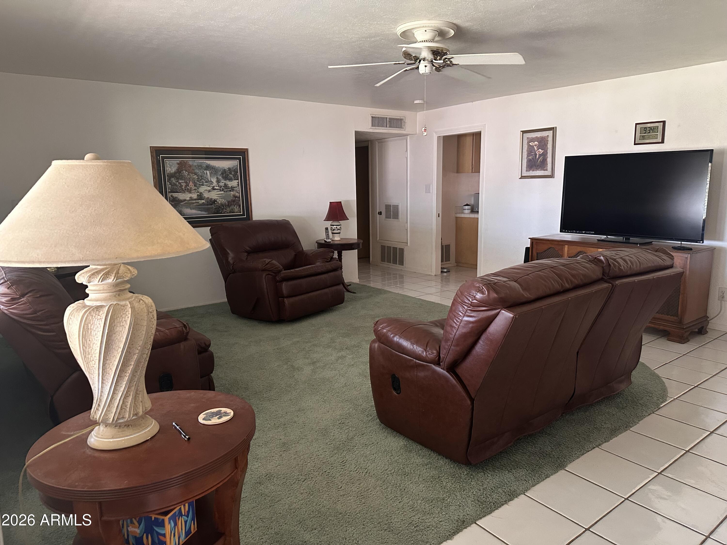 2821 West Elliot Road Laveen, AZ 85339 - Photo 8 of 92 a living room with furniture and a flat screen tv