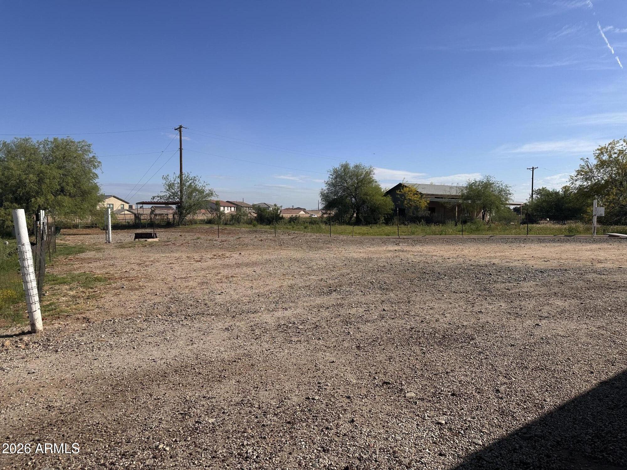 2821 West Elliot Road Laveen, AZ 85339 - Photo 87 of 92 a view of a field with an trees in the background