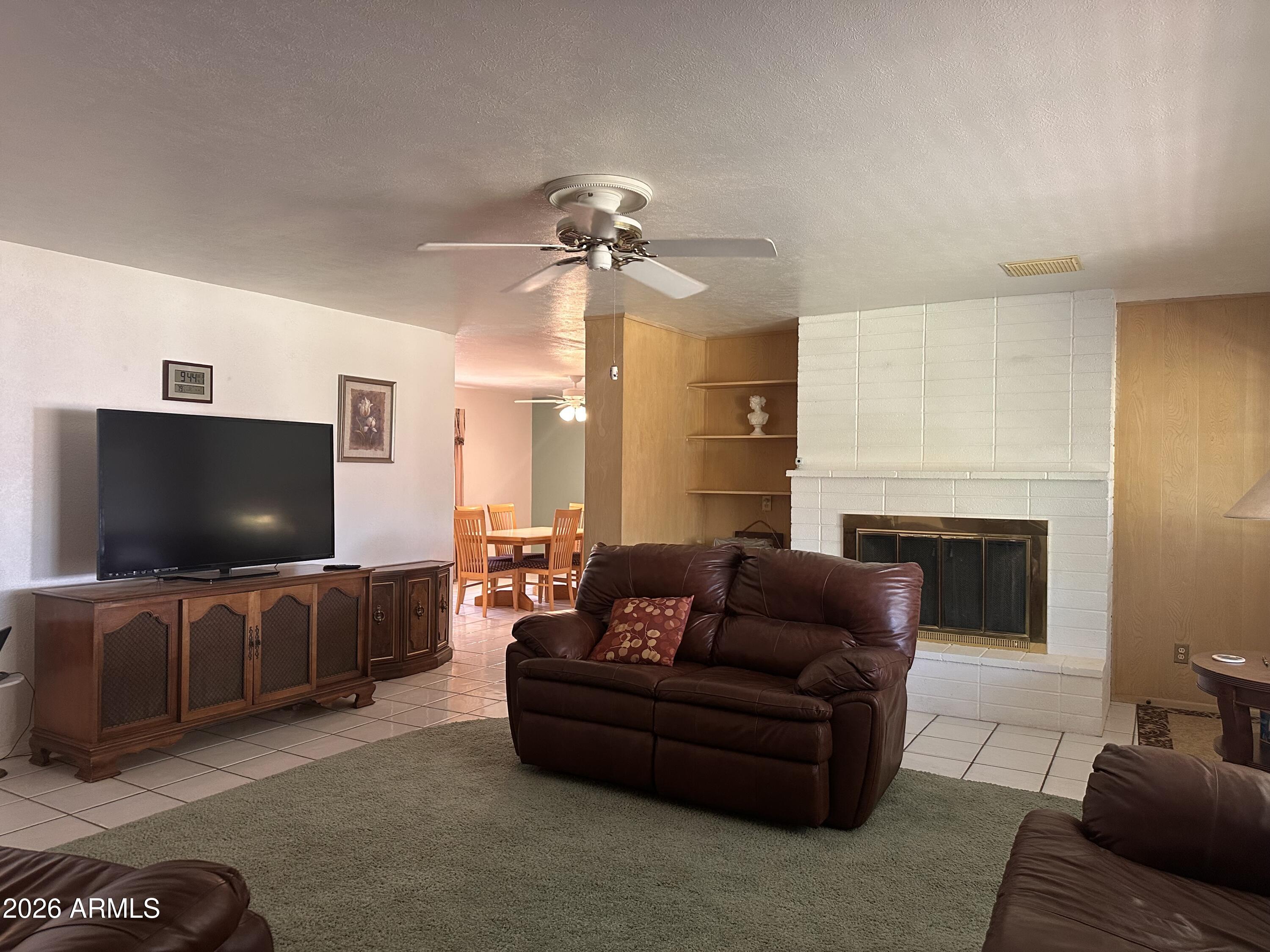 2821 West Elliot Road Laveen, AZ 85339 - Photo 9 of 92 a living room with furniture and a flat screen tv