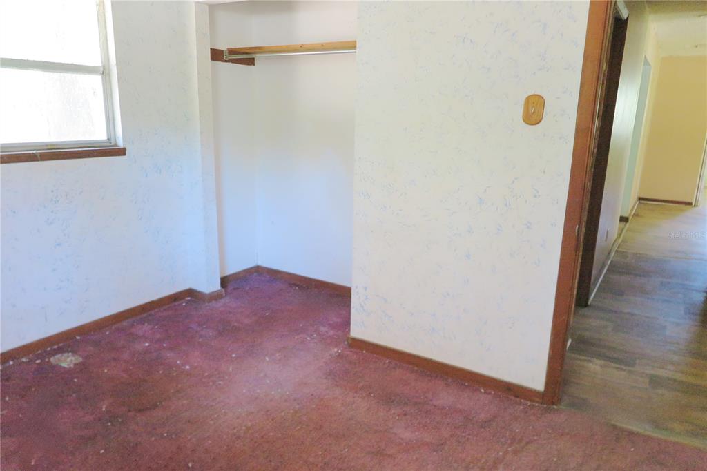153-UNIT Ranch Road San Mateo, FL 32187 - Photo 23 of 34 a view of a hallway with wooden floor