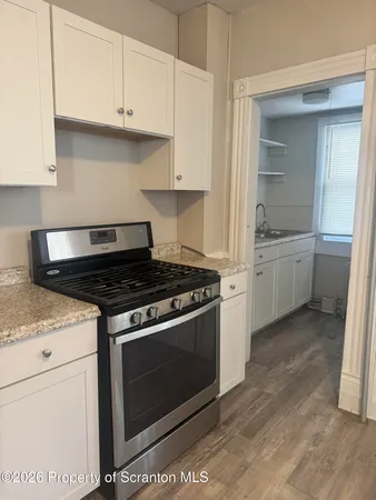 a stove top oven sitting inside of a kitchen