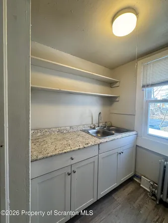 a kitchen with a sink cabinets and window