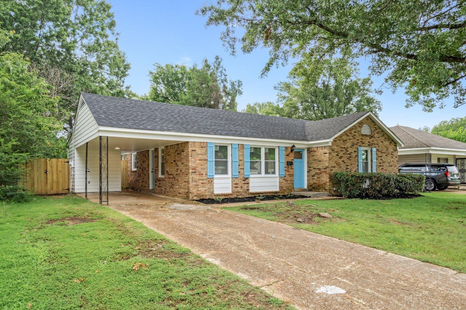 1864 Denison Street Memphis, TN 38111 - Photo 2 of 12 a front view of a house with a yard and garage