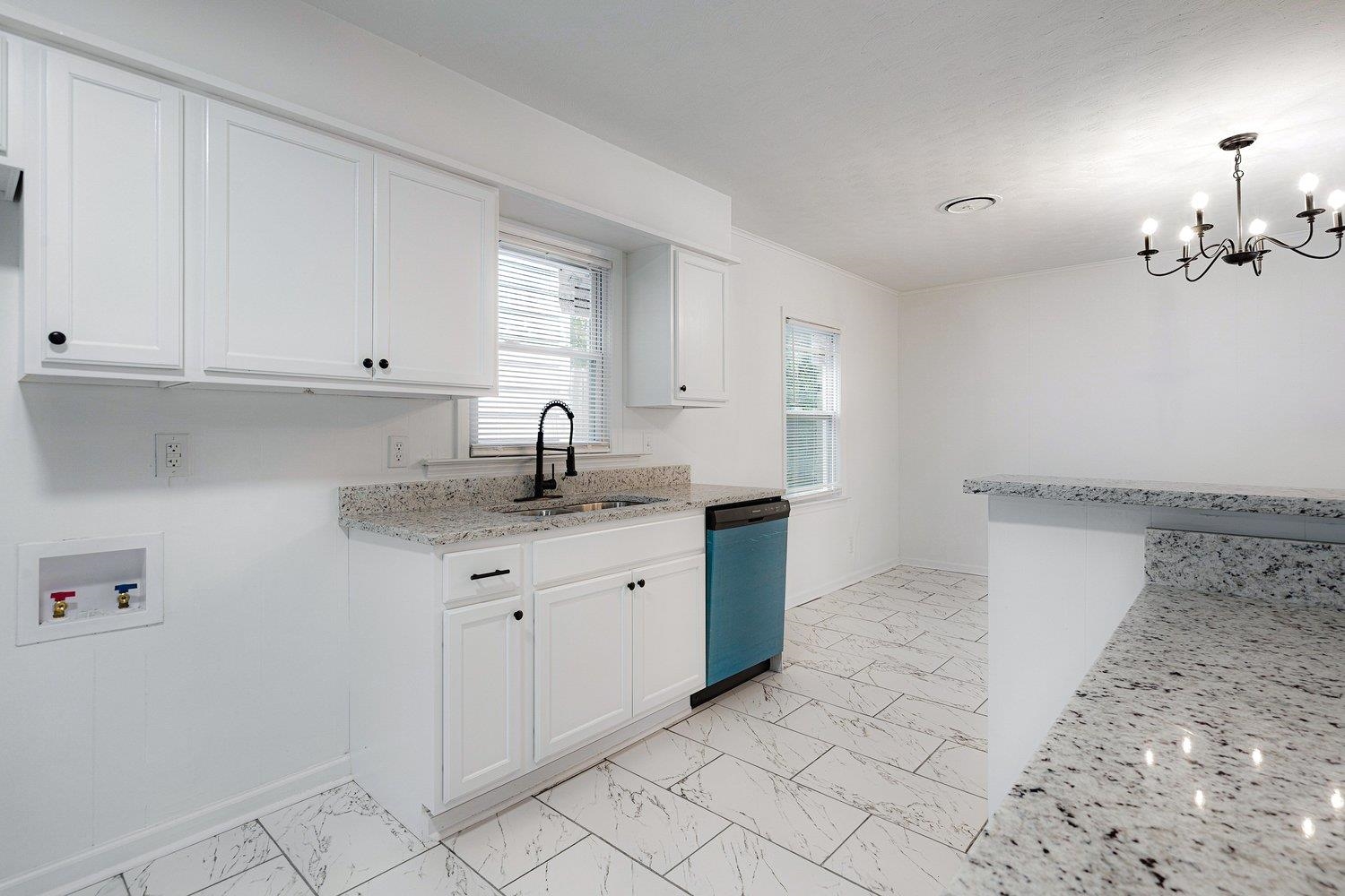 1864 Denison Street Memphis, TN 38111 - Photo 10 of 12 a kitchen with granite countertop white cabinets and a sink