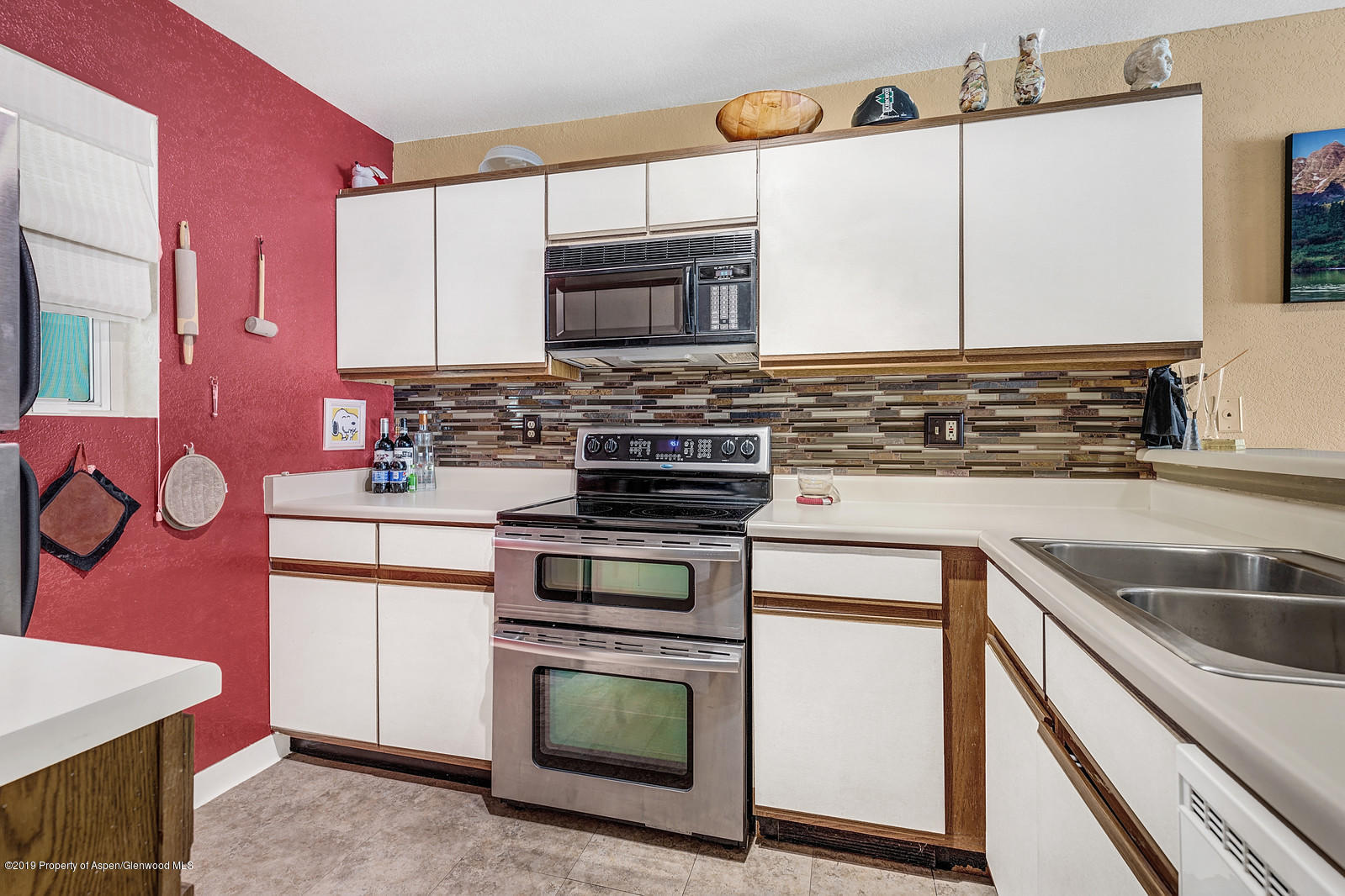 323 Park Avenue, Unit I3 Basalt, CO 81621 - Photo 2 of 10 a kitchen with stainless steel appliances granite countertop a stove microwave and refrigerator