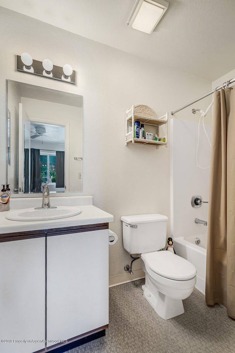 323 Park Avenue, Unit I3 Basalt, CO 81621 - Photo 8 of 10 a bathroom with a toilet a sink and mirror